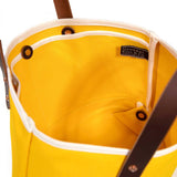 interior yellow canvas mini tote with brown leather handles
