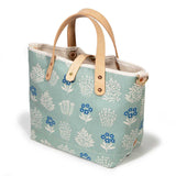 pale green floral print with blonde leather handles