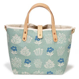pale green floral print with blonde leather handles