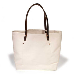 Neutral off-white tote in natural canvas with brown leather straps