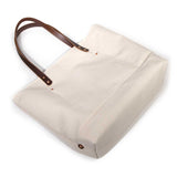Neutral off-white tote in natural canvas with brown leather straps