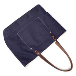 Navy waxed canvas tote with brown leather handles