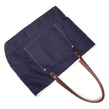 Navy waxed canvas tote with brown leather handles