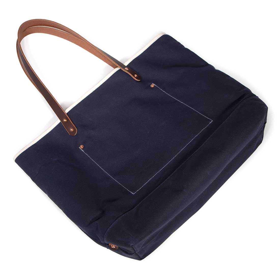 Navy waxed canvas tote with brown leather handles