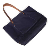 Navy waxed canvas tote with brown leather handles