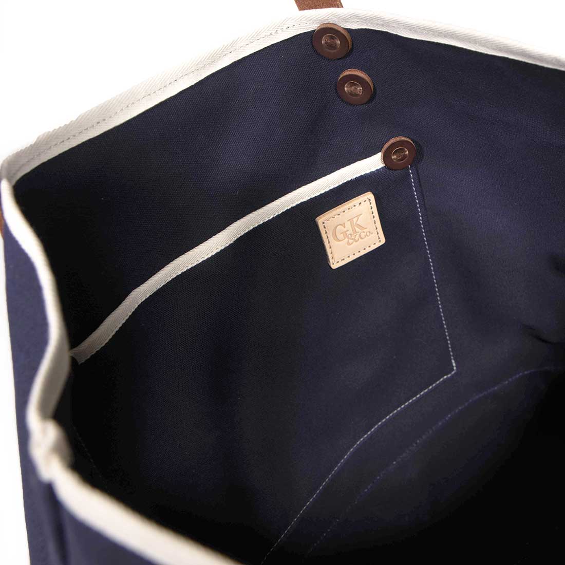 Interior Navy waxed canvas tote with brown leather handles