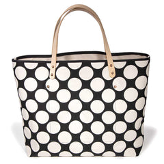 Bold white and black oversized dot print tote with blonde leather handles and canvas trim