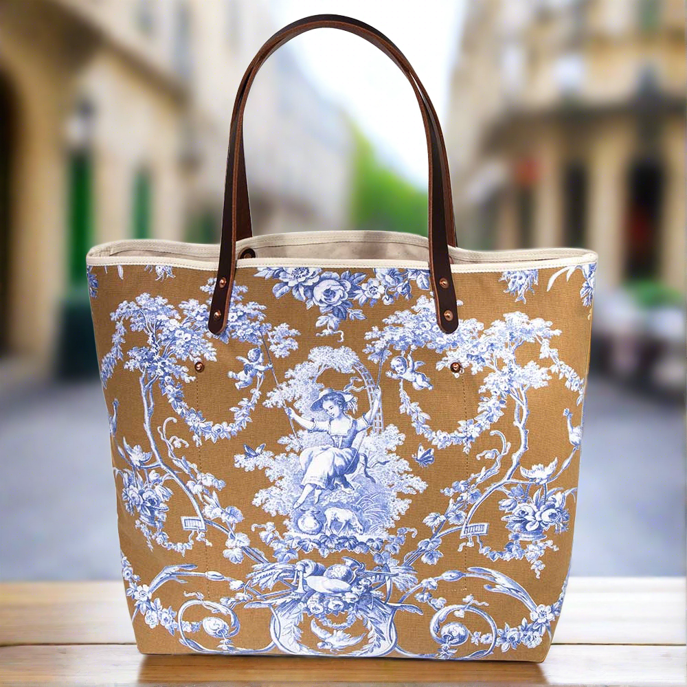 Lifestyle tote with oak and ink blue toile print with brown leather handles and natural canvas body
