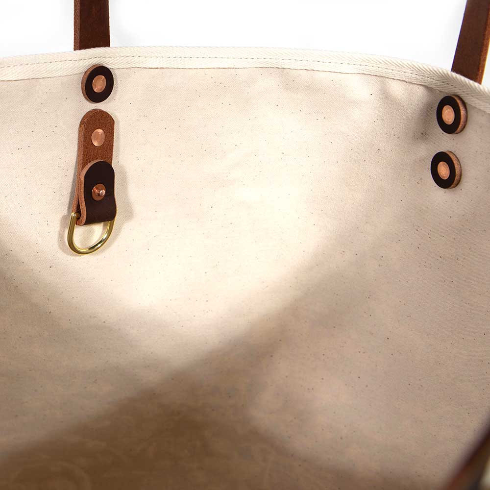 Interior tote with oak and ink blue toile print with brown leather handles and natural canvas body