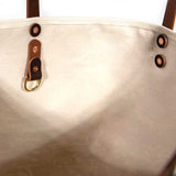 Interior tote with oak and ink blue toile print with brown leather handles and natural canvas body