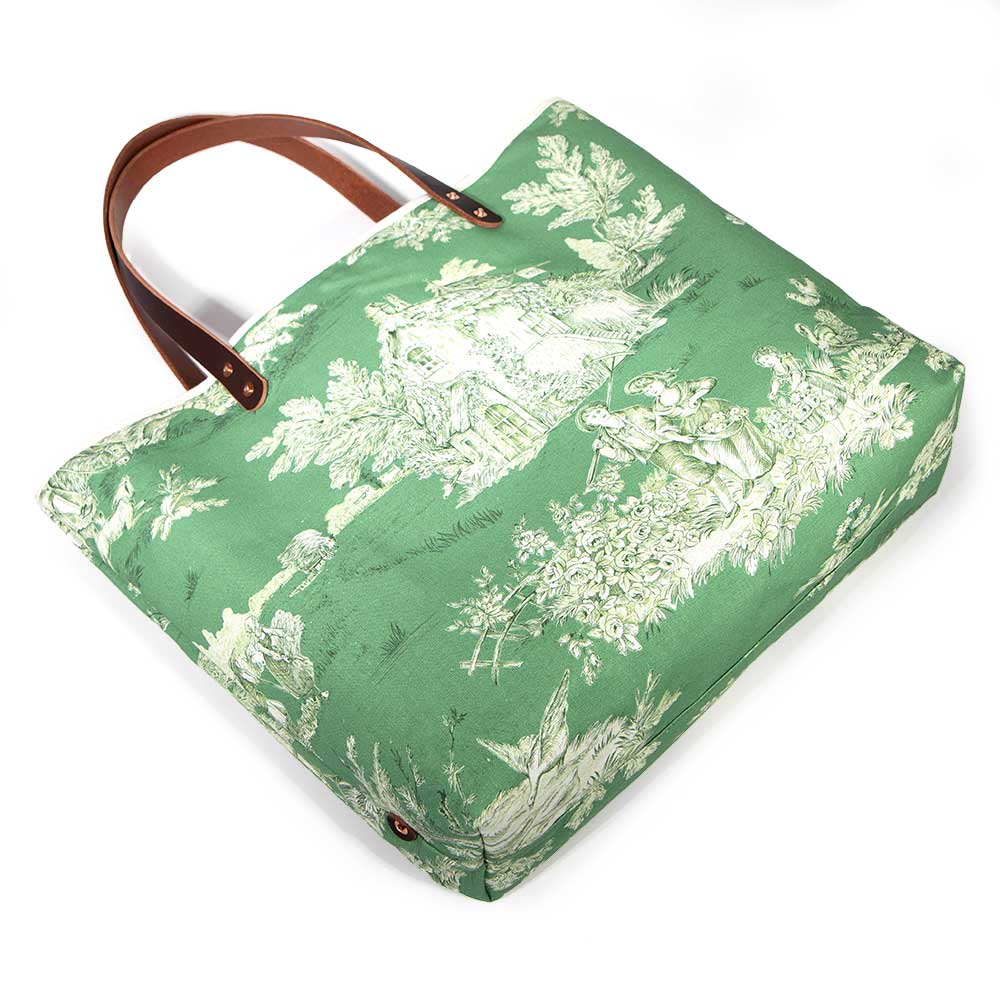 Emerald green toile print canvas tote with natural canvas top and brown leather handles