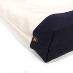 Detail Natural canvas tote with navy bottom and brown leather handles