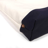 Detail Natural canvas tote with navy bottom and brown leather handles