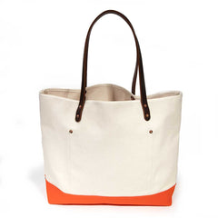 Natural canvas tote with orange bottom and dark brown leather handles