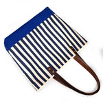 Navy and white stripe canvas tote with blue bottom and brown leather handles