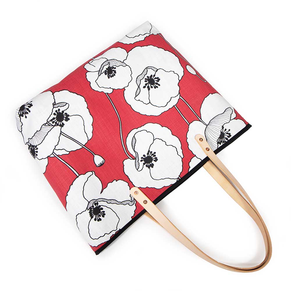 French Provençal-inspired canvas tote with red poppy print and blonde leather straps
