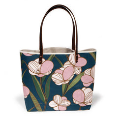 tote with floral pattern in pink and blue, with brown leather handles