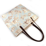 pale blue toile fabric tote bag with dark mahogany leather handles