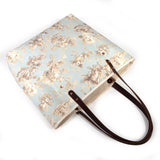 pale blue toile fabric tote bag with dark mahogany leather handles