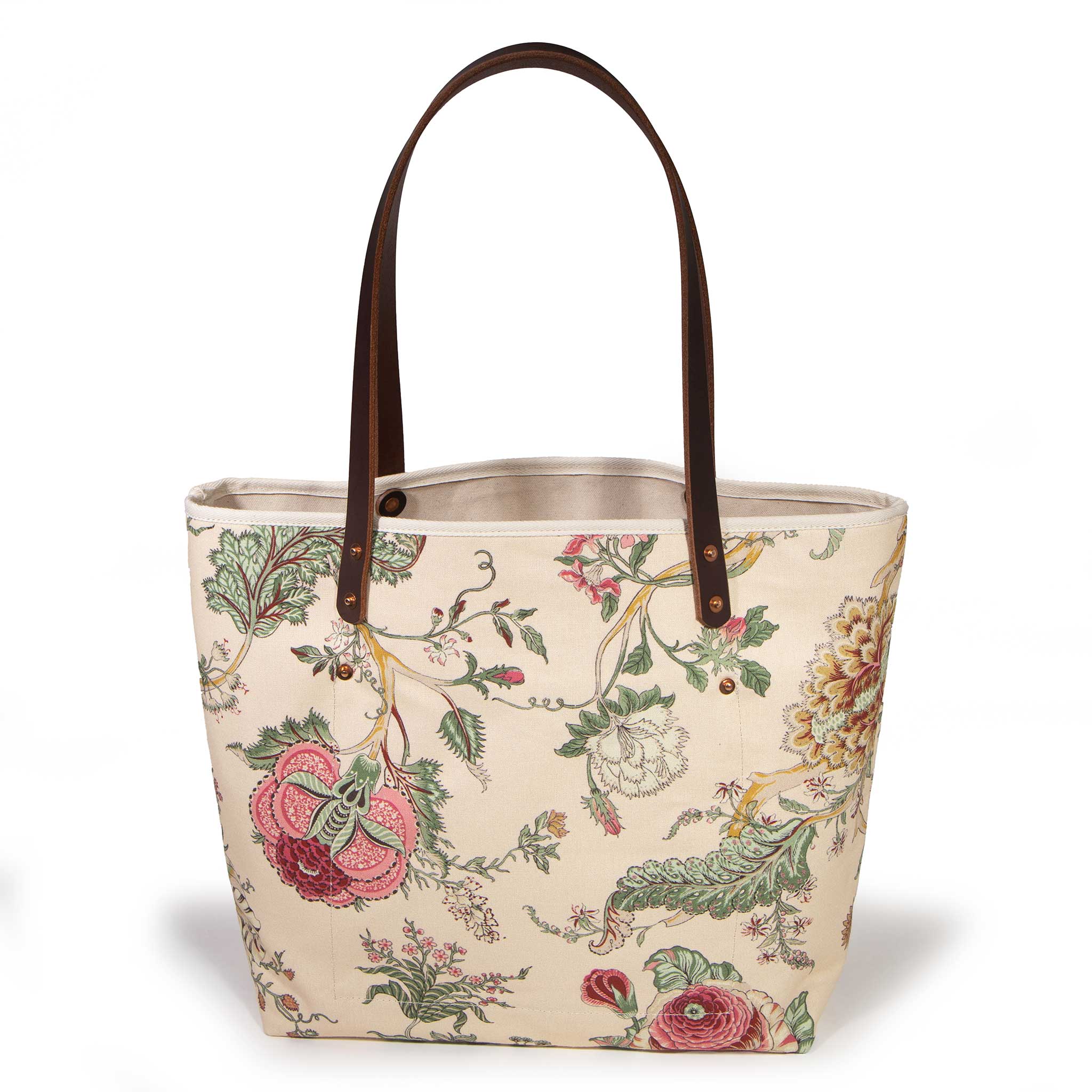 Botanique All Day Tote, front view — cream canvas with pink and gold botanical print, mahogany leather handles