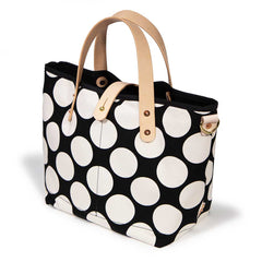 Bold black and white oversized dot print tote with blonde leather handles