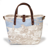 Back of the powder blue Seaside Toile Mini Tote, children wading with nets beneath a seaside tree