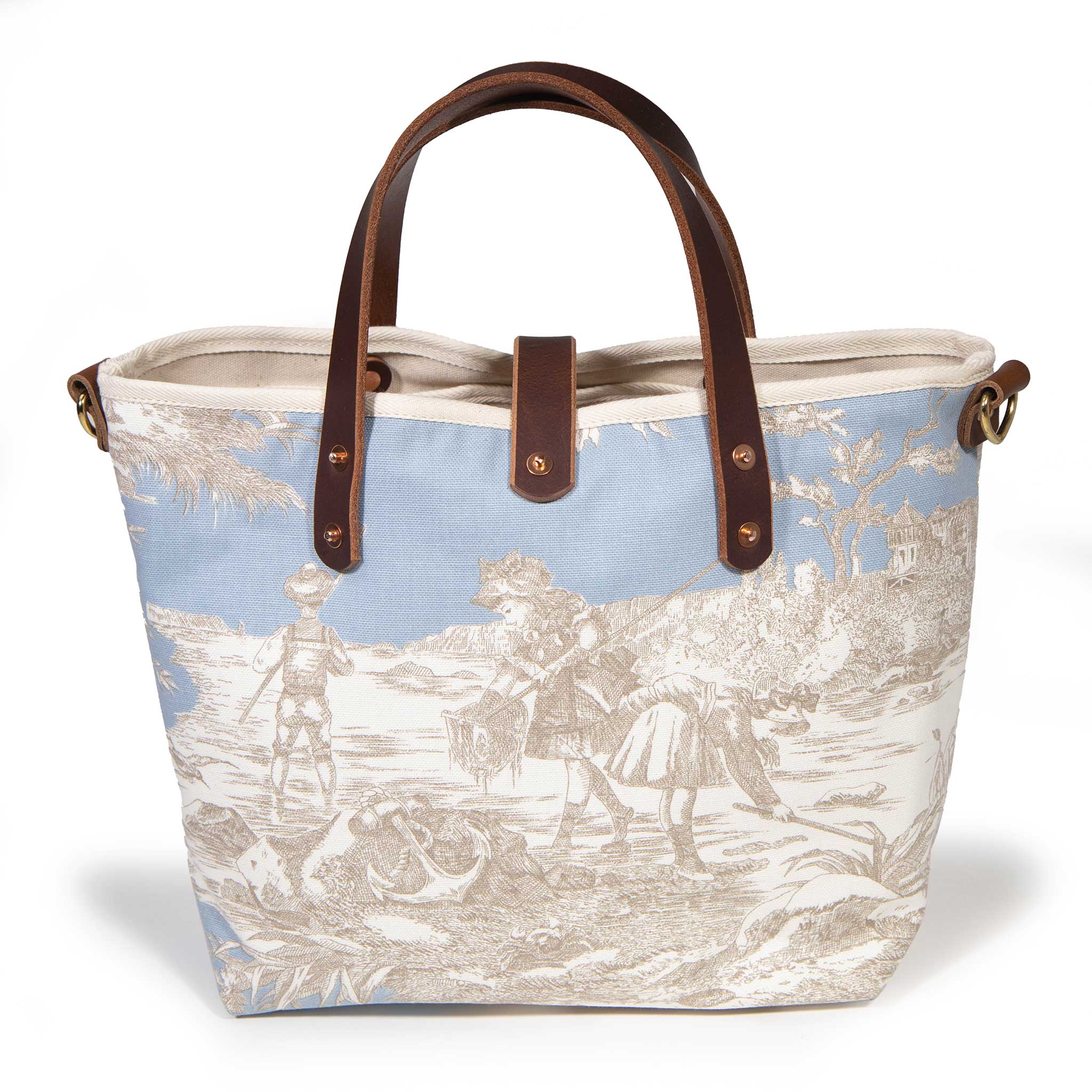 Back of the powder blue Seaside Toile Mini Tote, children wading with nets beneath a seaside tree