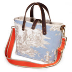 Powder blue Seaside Toile Mini Tote worn with the Flame/Tan striped cotton crossbody strap