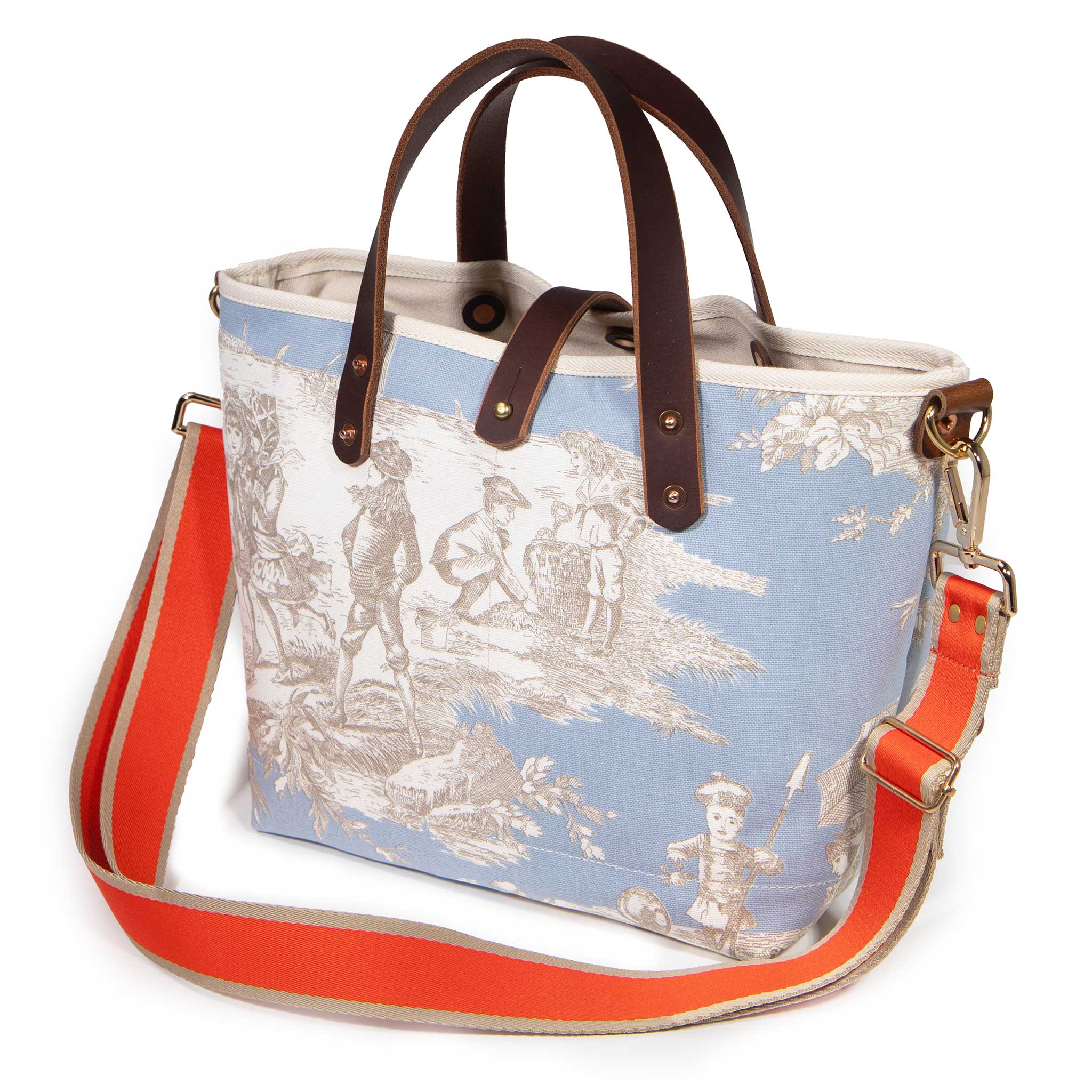 Powder blue Seaside Toile Mini Tote worn with the Flame/Tan striped cotton crossbody strap