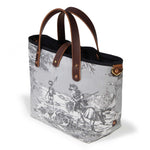 Seaside Toile Mini Tote in fog grey, three-quarter view, with mahogany leather handles and a brass D-ring