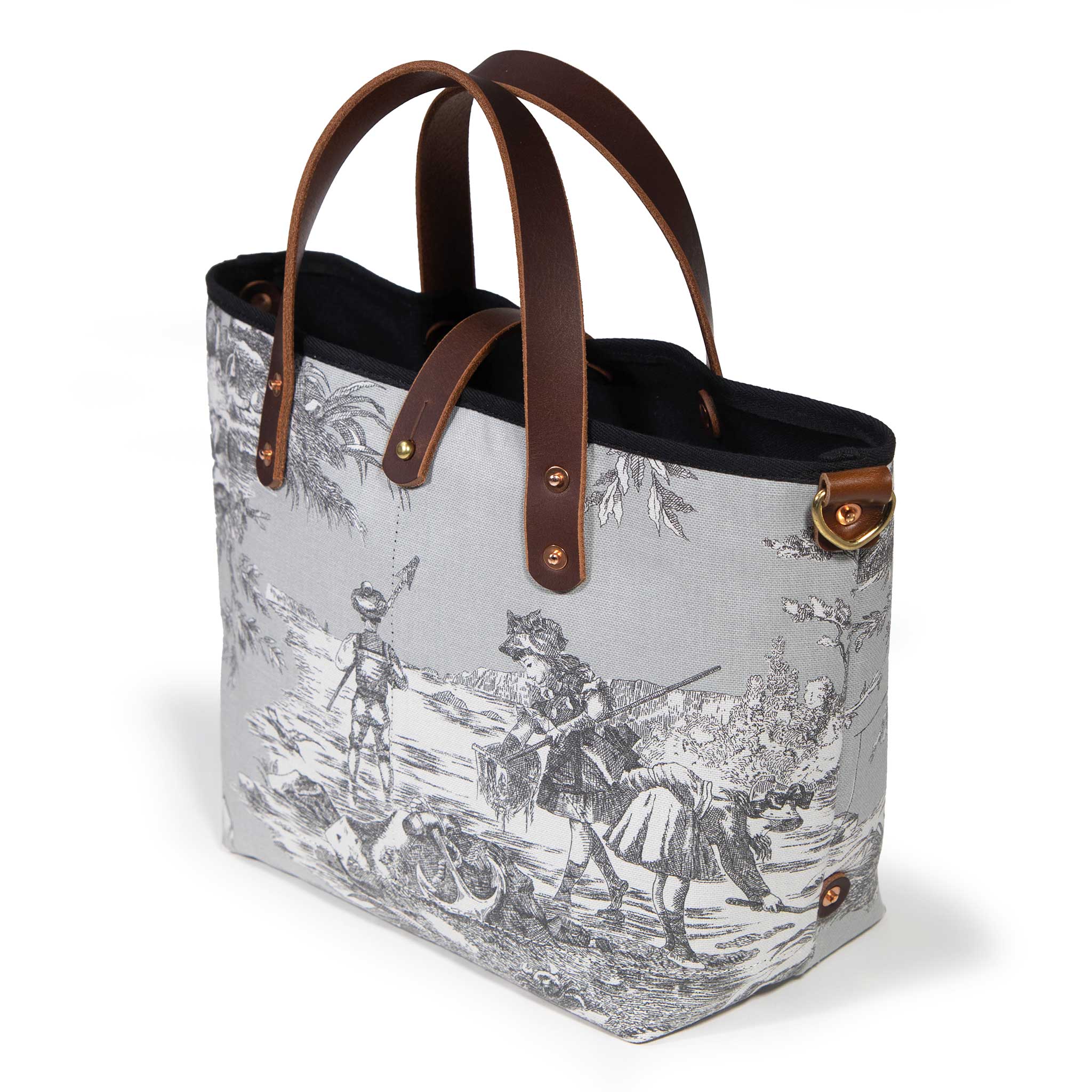 Seaside Toile Mini Tote in fog grey, three-quarter view, with mahogany leather handles and a brass D-ring