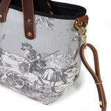 Close-up of the brass D-ring and swivel clip on the fog grey Seaside Toile Mini Tote, with copper rivets on the handles