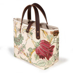 Botanique Floral Print Mini Tote, three-quarter view, a deep rose bloom on cream with mahogany leather handles and a brass D-ring