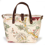 Back of the Botanique Floral Print Mini Tote, a large pale leaf and pink blossoms on cream