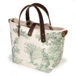 Butter and Pine Toile Mini Tote, three-quarter view, pine green toile on cream with mahogany leather handles and a brass D-ring