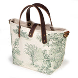 Butter and Pine Toile Mini Tote, three-quarter view, pine green toile on cream with mahogany leather handles and a brass D-ring