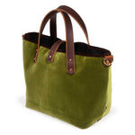Luxe Velvet Mini Tote in peridot green, three-quarter view, with brown velvet binding, mahogany leather handles and a brass D-ring