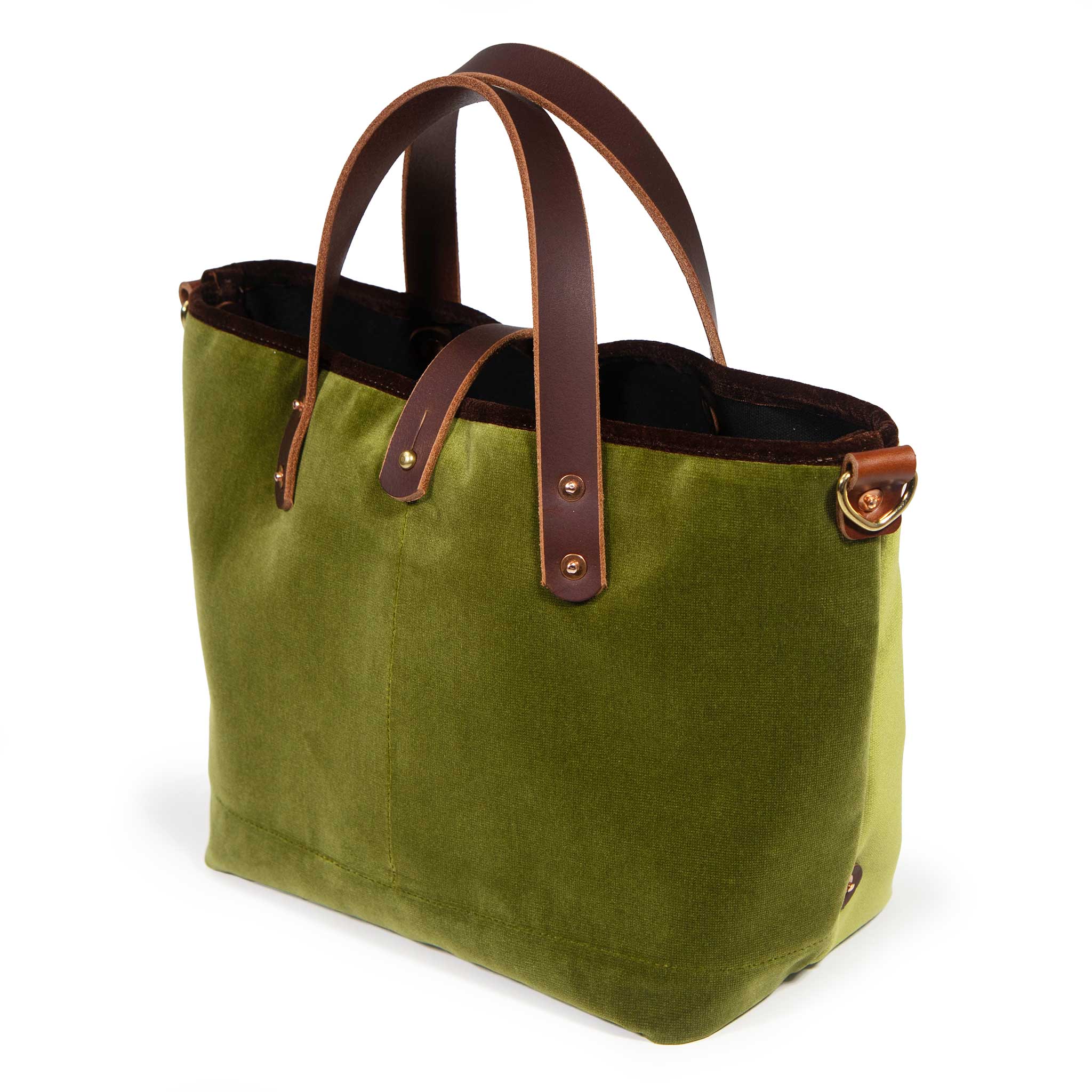 Luxe Velvet Mini Tote in peridot green, three-quarter view, with brown velvet binding, mahogany leather handles and a brass D-ring