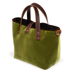 Luxe Velvet Mini Tote in peridot green, three-quarter view, with brown velvet binding, mahogany leather handles and a brass D-ring