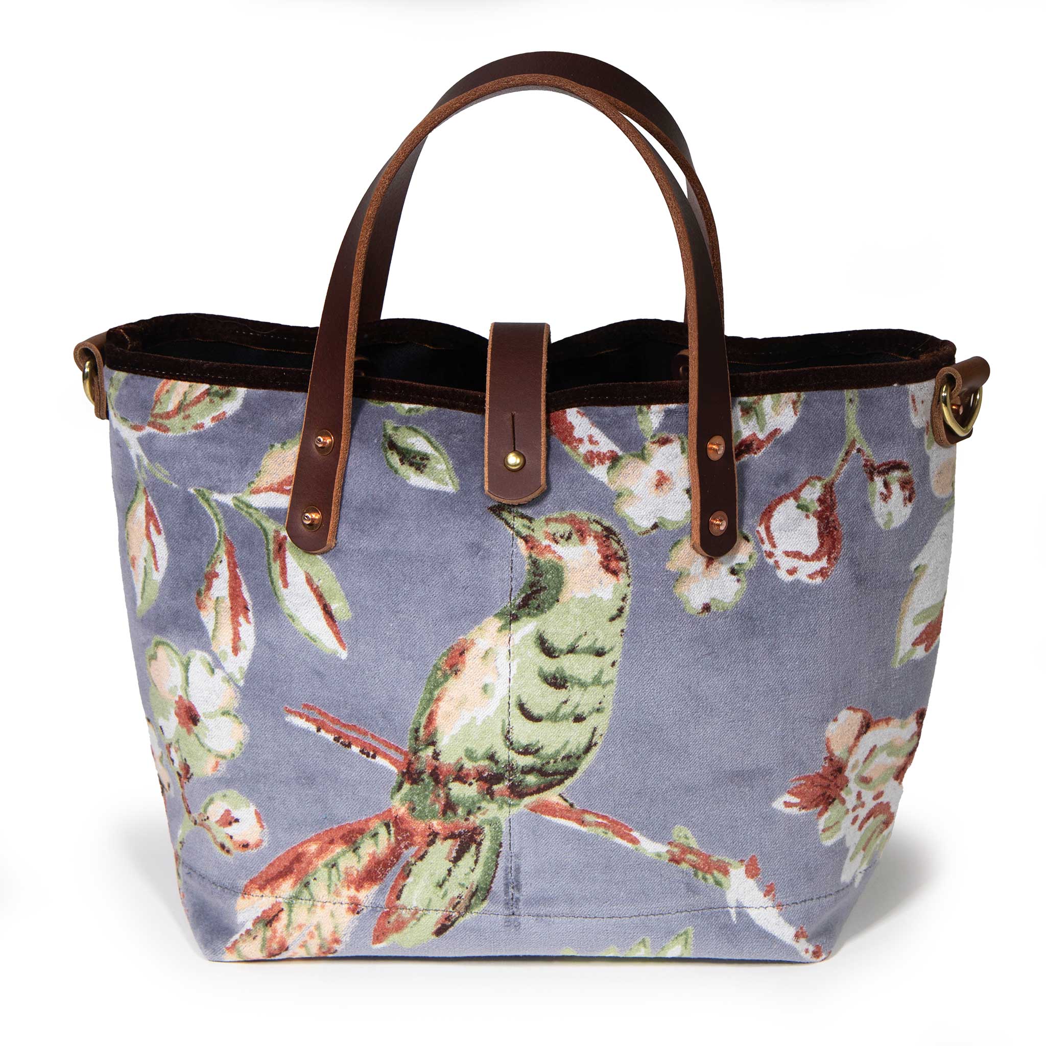 Aviary Luxe Velvet Mini Tote, front view: a green songbird on a blossoming branch, hand-printed on dove grey cotton velvet, with mahogany leather handles and a brass button closure