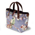 Aviary Luxe Velvet Mini Tote, three-quarter view showing the brown velvet binding and a brass D-ring at the side