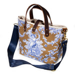 shoulder strap mini tote featuring oak and ink blue toile print with brown leather handles