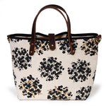 black and white floral mini tote with brown leather handles