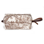 Side view of the Horse Country Toile Travel Kit, a brown linen toile dopp kit with leather handle