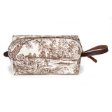 Side view of the Horse Country Toile Travel Kit, a brown linen toile dopp kit with leather handle