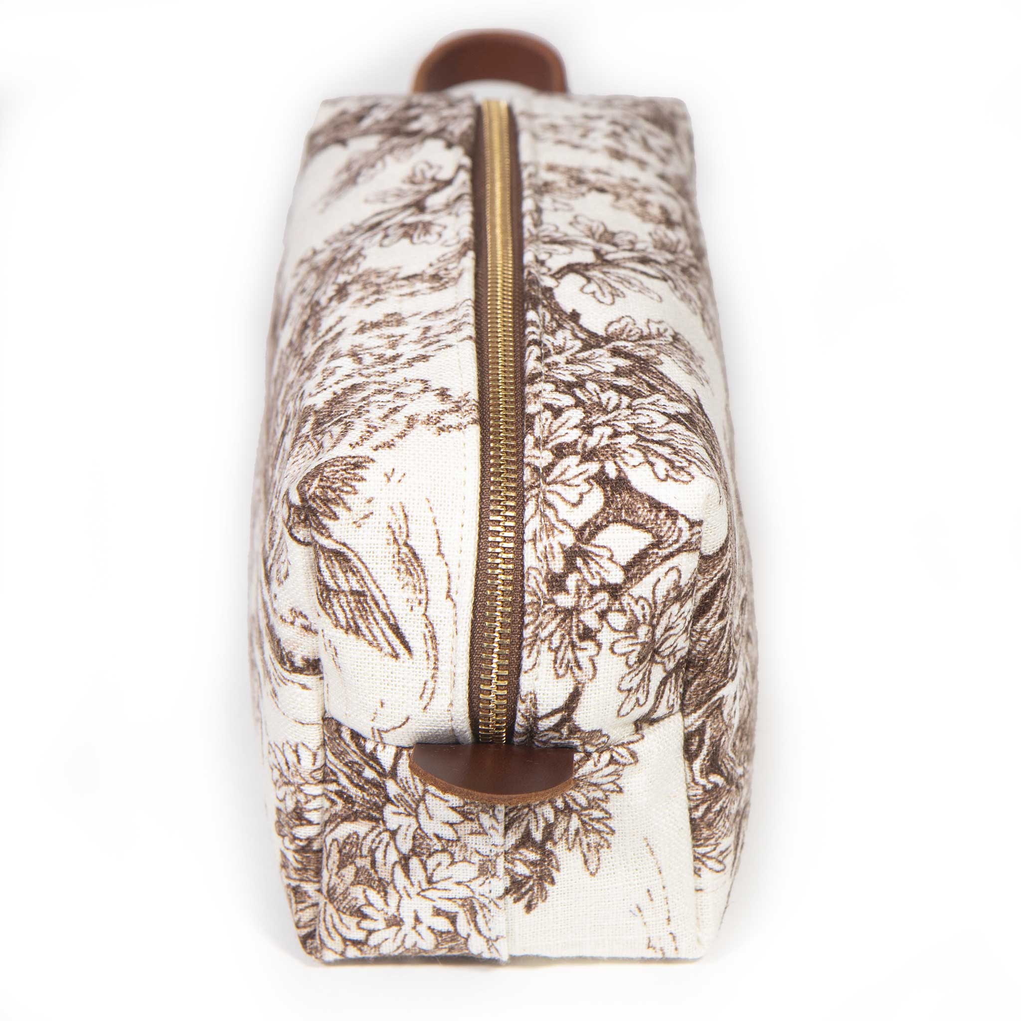 Top view along the brass zipper of the Horse Country Toile Travel Kit, leather handle at the far end
