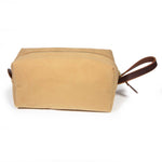 Front of the Camel Microsuede Travel Kit, a structured camel dopp kit with a mahogany leather handle at one end