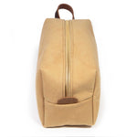 End view of the Camel Microsuede Travel Kit with the mahogany logo leather tab and brass zipper