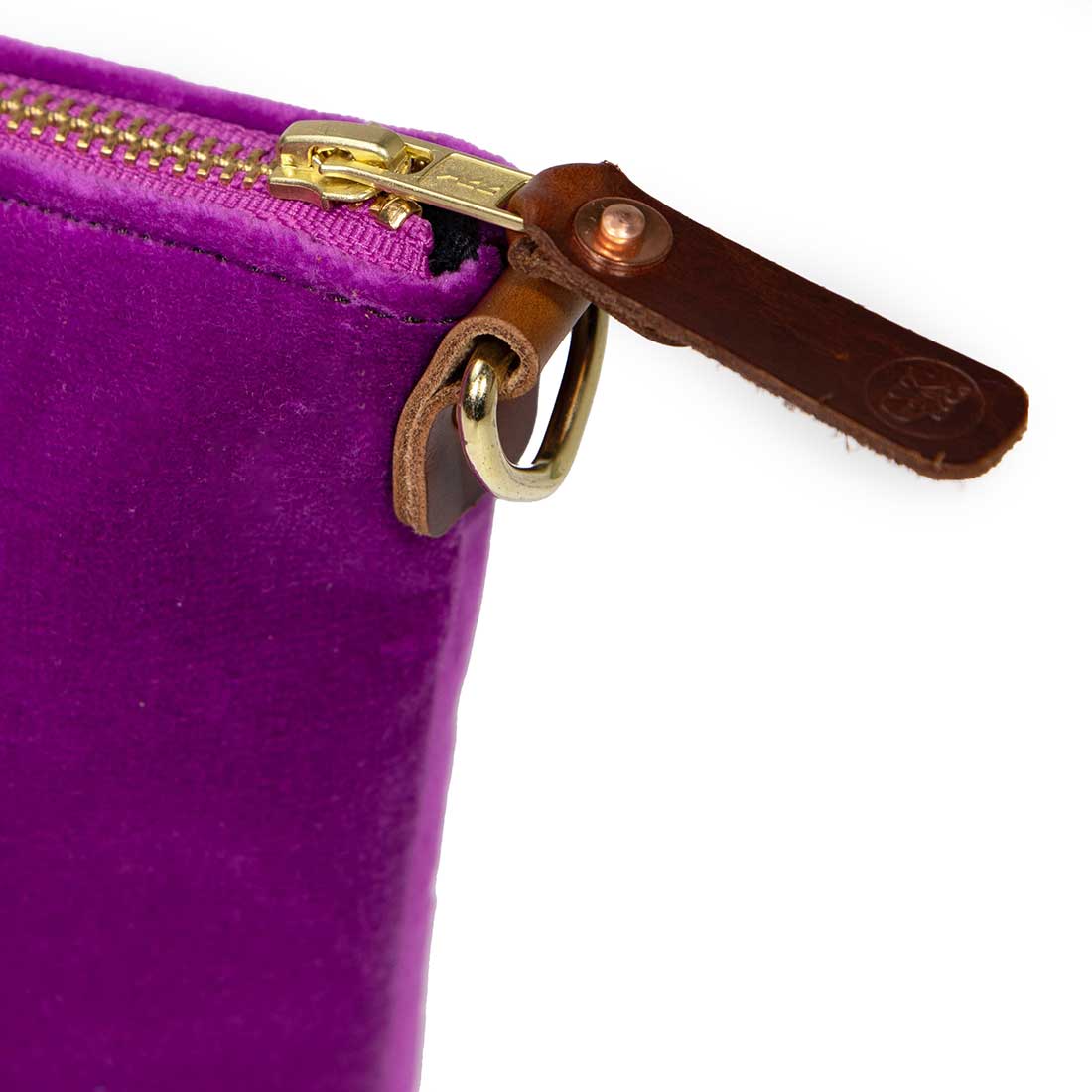detail purple velvet clutch with brown leather d-ring holders