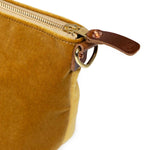 detail golden velvet clutch with brown leather d-ring holders